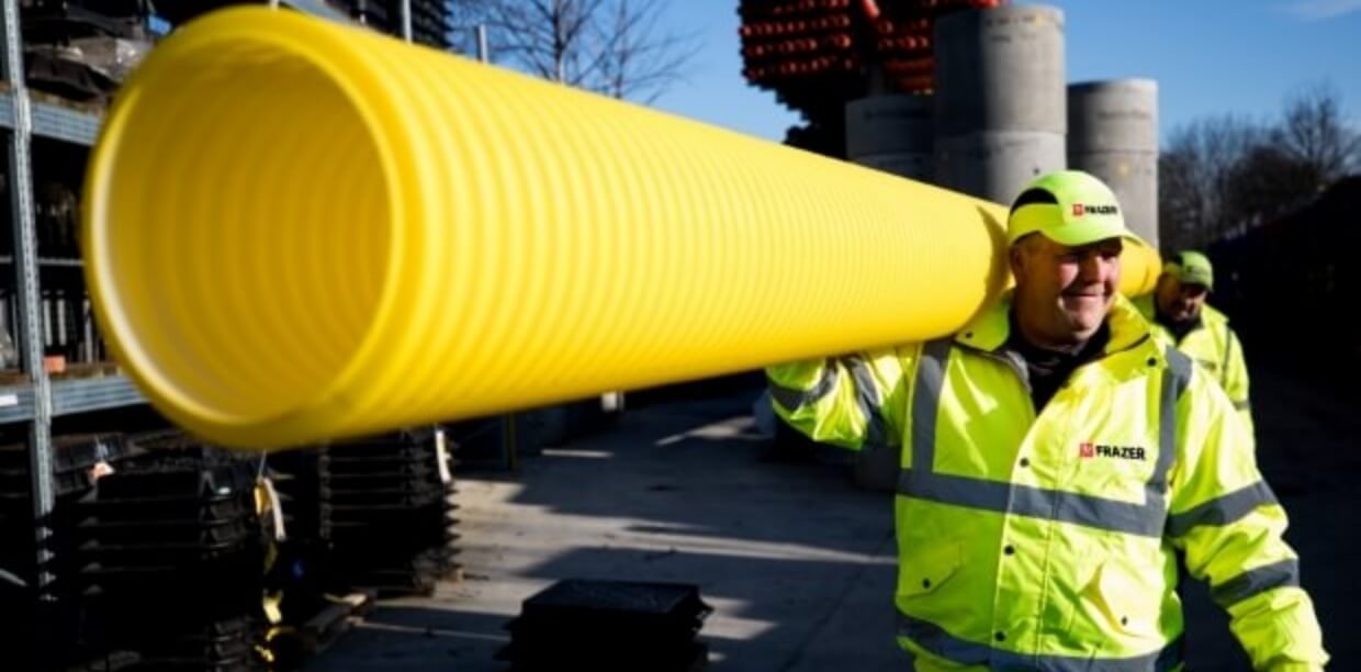 An image of a man in hi-vis clothing carrying utilities materials.